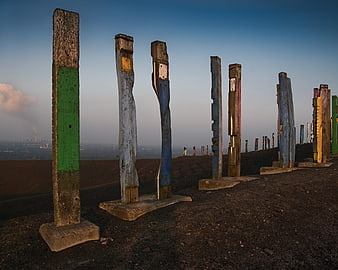 Weathered Wooden Posts on Dark Earth Hill at Dusk