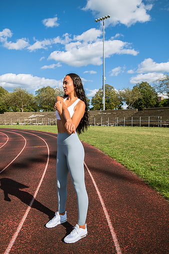 Female Athlete Stretching on Outdoor Running Track