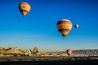 Hot Air Balloons Flying Over Cappadocia Landscape