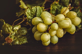 Fresh Green Grapes With Leaves On Dark Wooden Surface