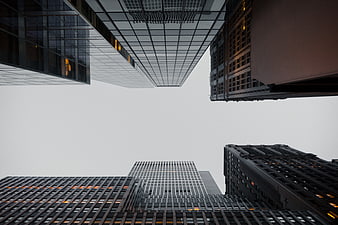 Low angle view of modern skyscrapers against gray sky