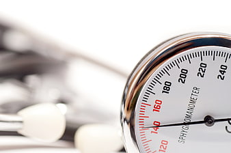 Close-up of a Sphygmomanometer Gauge and Stethoscope on White Background