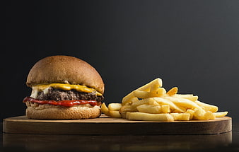 Cheeseburger and French Fries on Wooden Board