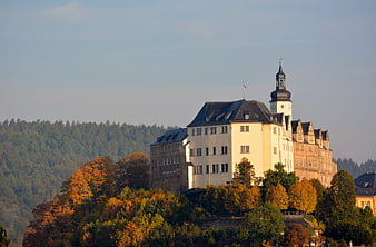 Historic Castle on Hilltop with Autumn Foliage
