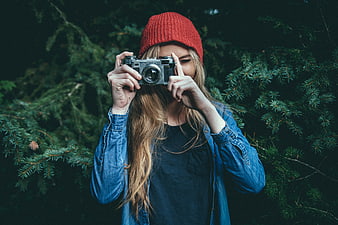 Woman with Vintage Camera in Pine Forest