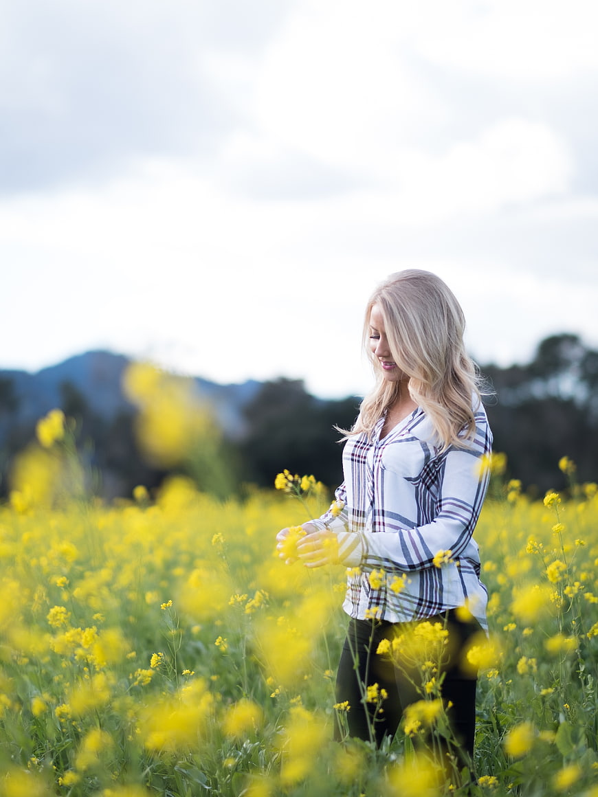 Blonde Woman Smiling in Yellow Flower Field