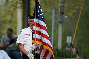 Senior Veteran Honor Guard Member Holding American Flag