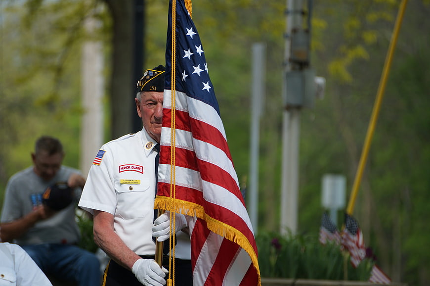 Senior Veteran Honor Guard Member Holding American Flag