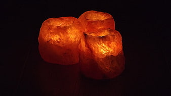 Glowing Himalayan Salt Lamps Illuminated Against Dark Background