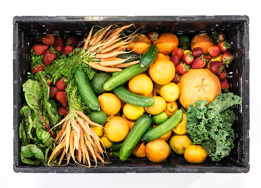 Top-Down View of Fresh Organic Produce in Black Plastic Crate