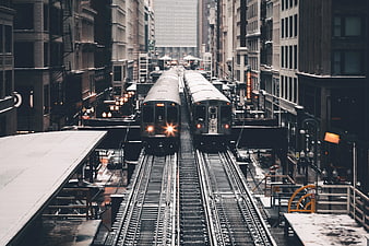 Two Subway Trains on Elevated Tracks in Urban City