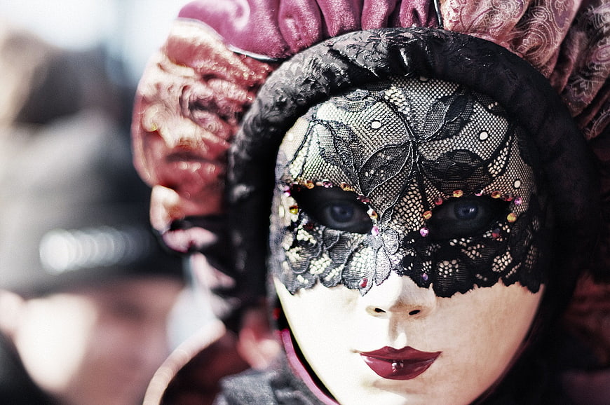Close-up of woman in ornate black lace masquerade mask