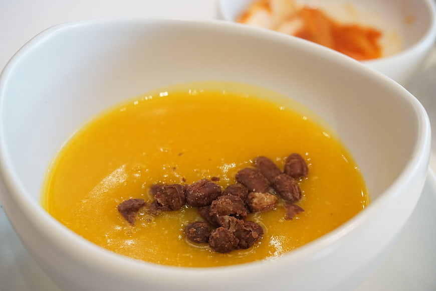 Korean Pumpkin Porridge with Jujube in White Ceramic Bowl