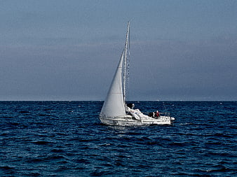 White Sailboat Sailing on Deep Blue Ocean