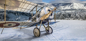 Vintage Bristol Scout biplane parked on snowy mountain airfield