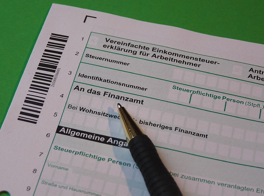 German Tax Return Form with Pen on Green Background