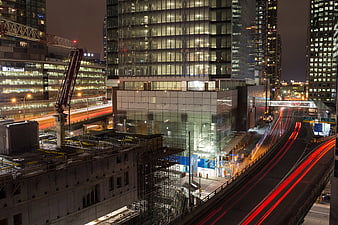Night Cityscape with Construction Crane and Traffic Light Trails