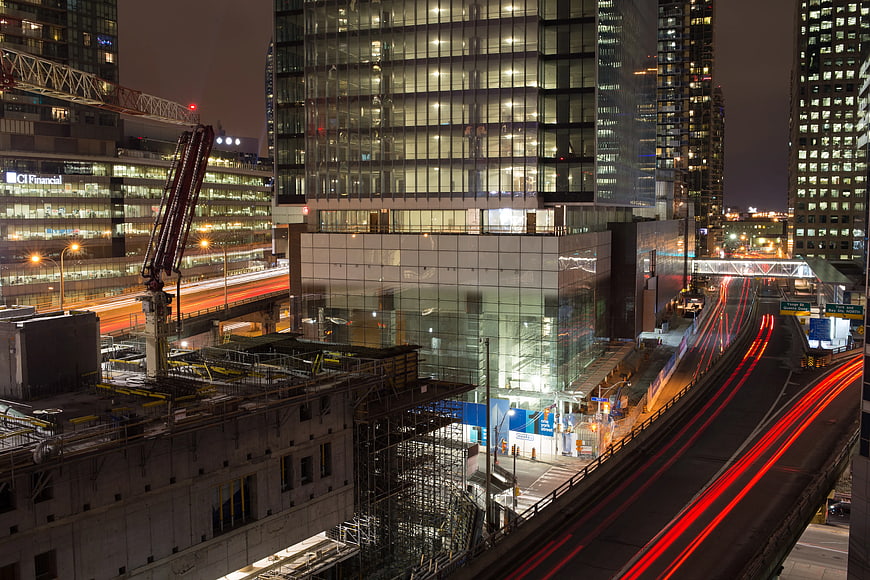 Night Cityscape with Construction Crane and Traffic Light Trails
