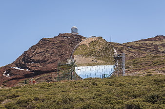 Radio telescope and observatory dome on volcanic mountain