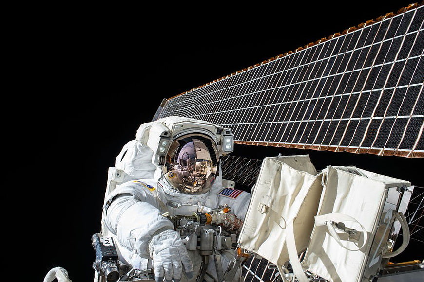 Astronaut Spacewalk with Solar Panel Background