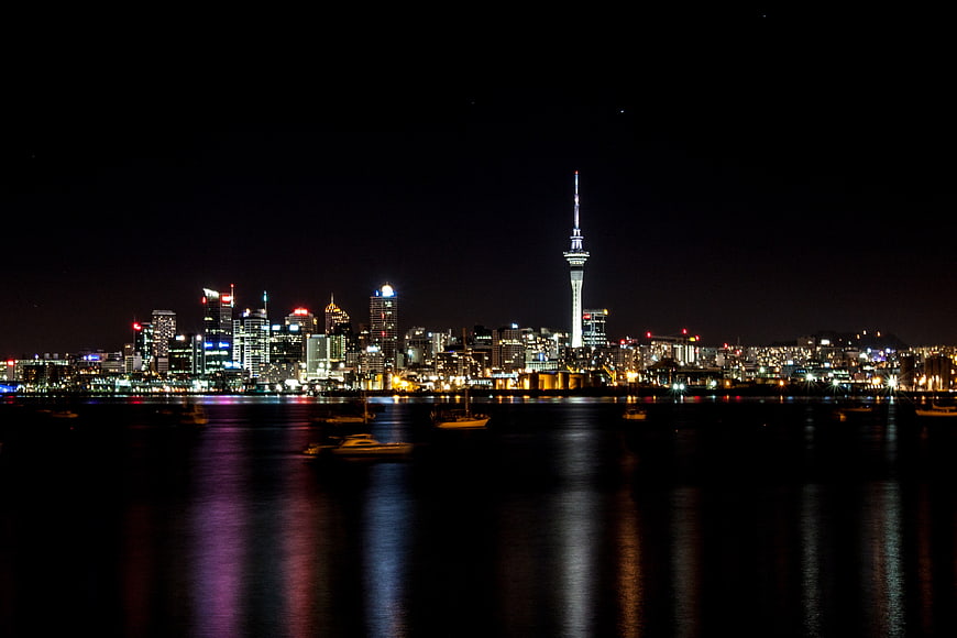 Auckland Skyline Night View With Sky Tower And Water Reflections