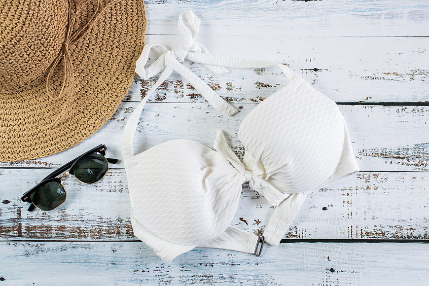 White Bikini Top, Straw Hat, and Sunglasses Flat Lay