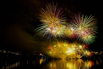 Colorful Fireworks Display Over Water at Night