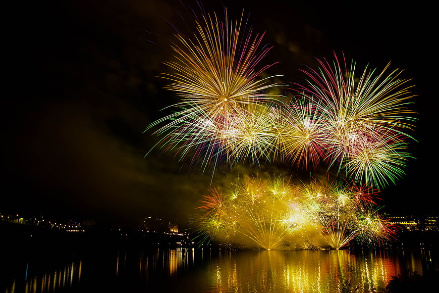 Colorful Fireworks Display Over Water at Night