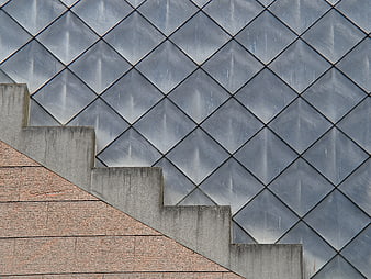 Modern geometric architecture with diamond pattern and concrete stairs