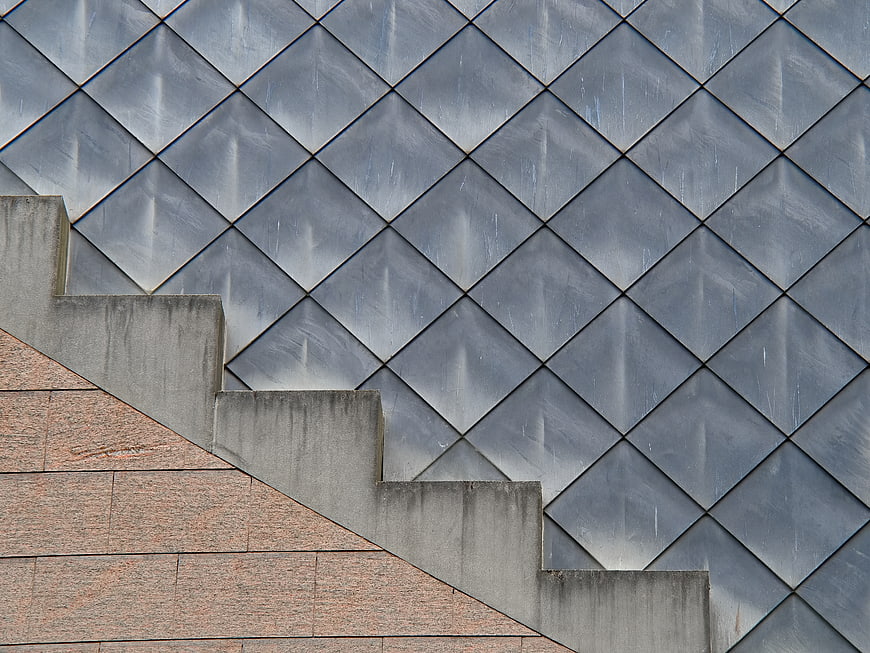 Modern geometric architecture with diamond pattern and concrete stairs