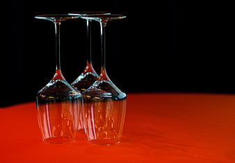Upside down wine glasses on red table