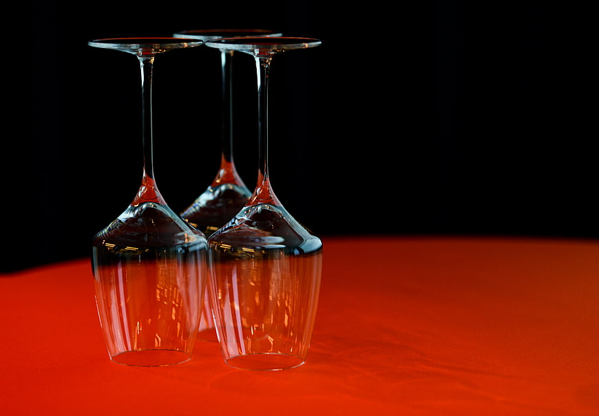 Upside down wine glasses on red table
