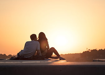 Couple Watching Sunset on Rooftop at Golden Hour