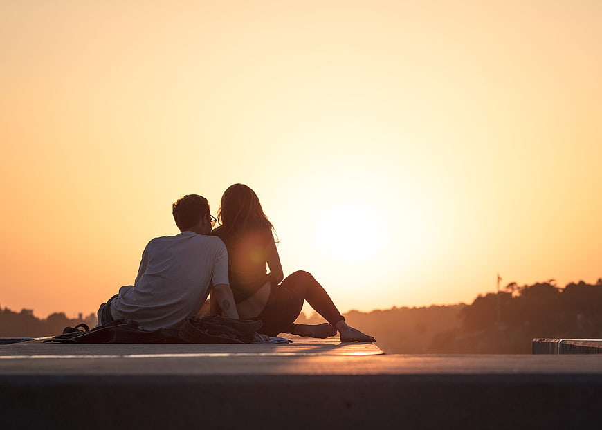 Couple Watching Sunset on Rooftop at Golden Hour