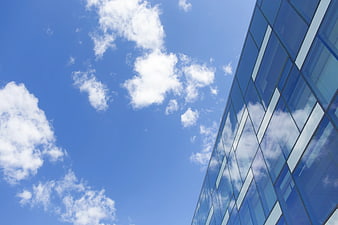 Modern Glass Building Facade Against Blue Sky