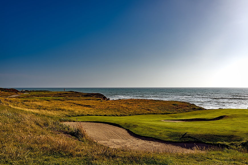 Scenic coastal golf course with sand bunker and ocean view