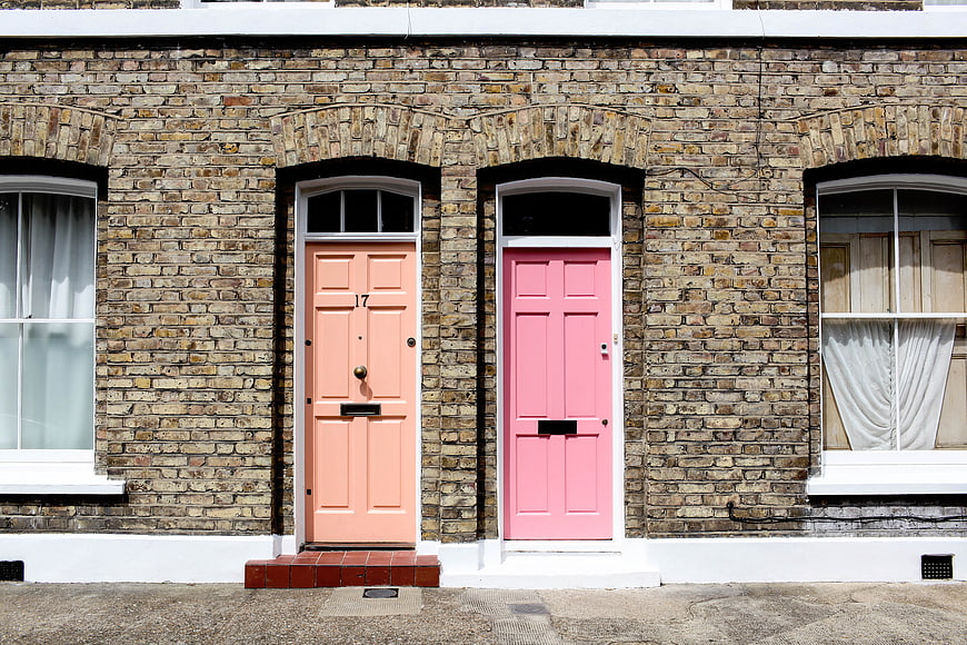 Colorful Pink and Peach Doors on Brick Building
