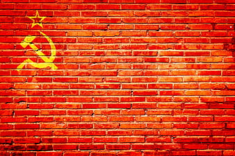 Yellow Soviet Hammer and Sickle Symbol on Red Brick Wall