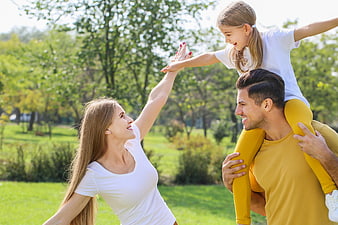 Happy family playing together in a sunny park