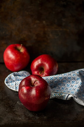 Three Red Apples on Dark Rustic Background with Cloth