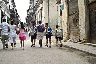 Children Walking Down Historic Street in Cuba