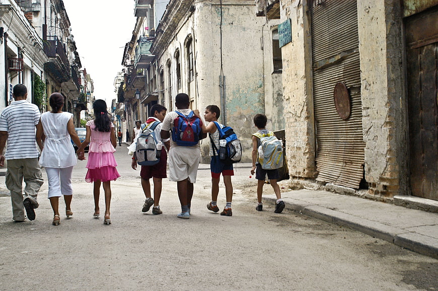 Children Walking Down Historic Street in Cuba