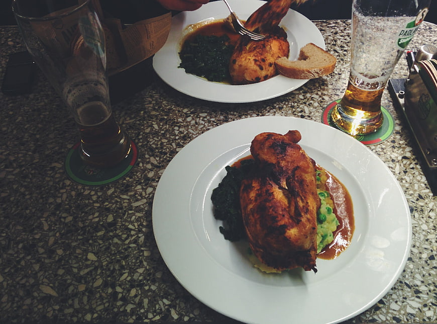 Roasted chicken dinner with beer in a restaurant