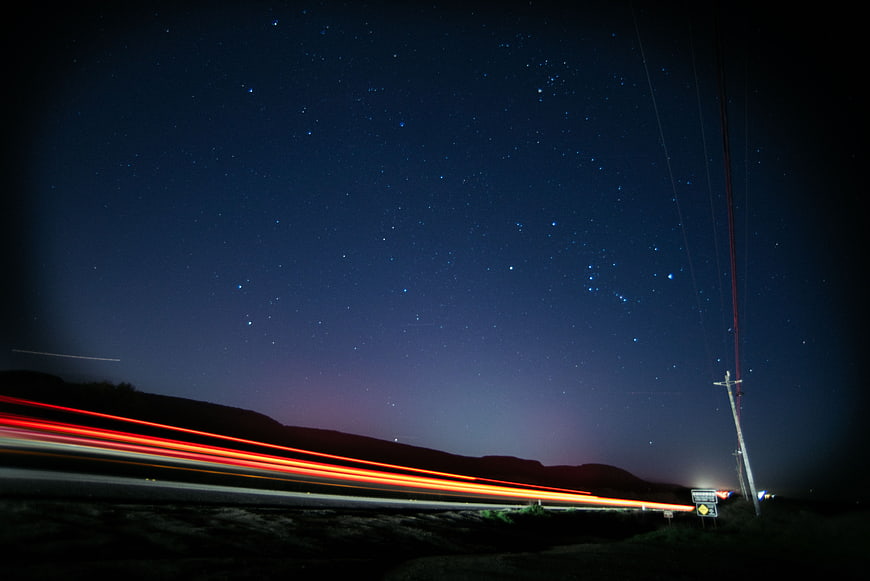 Long Exposure Night Sky with Car Light Trails on Highway