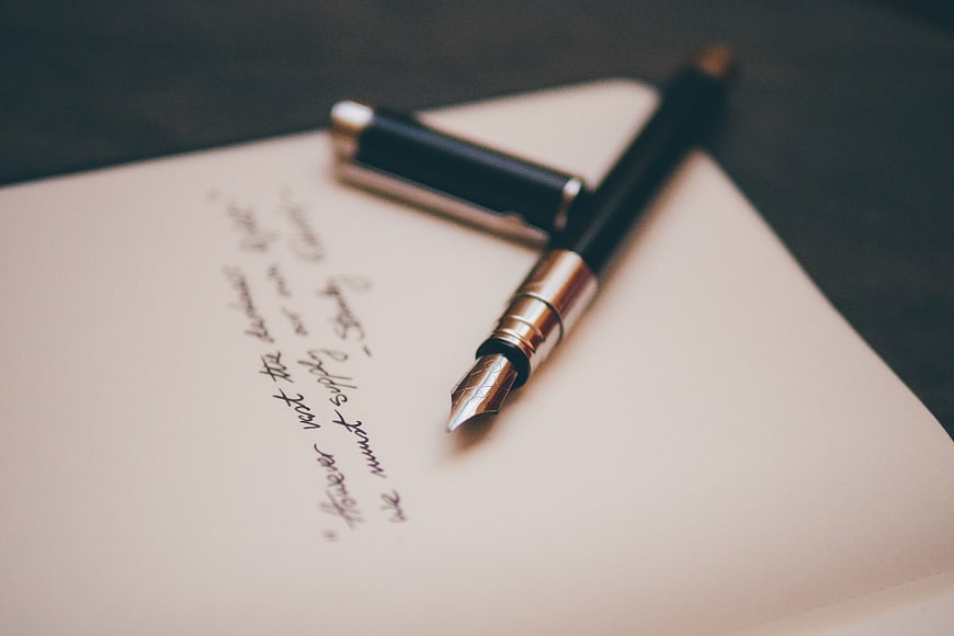 Vintage fountain pen on handwritten paper