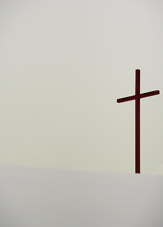 Minimalist Wooden Cross Against Foggy White Background