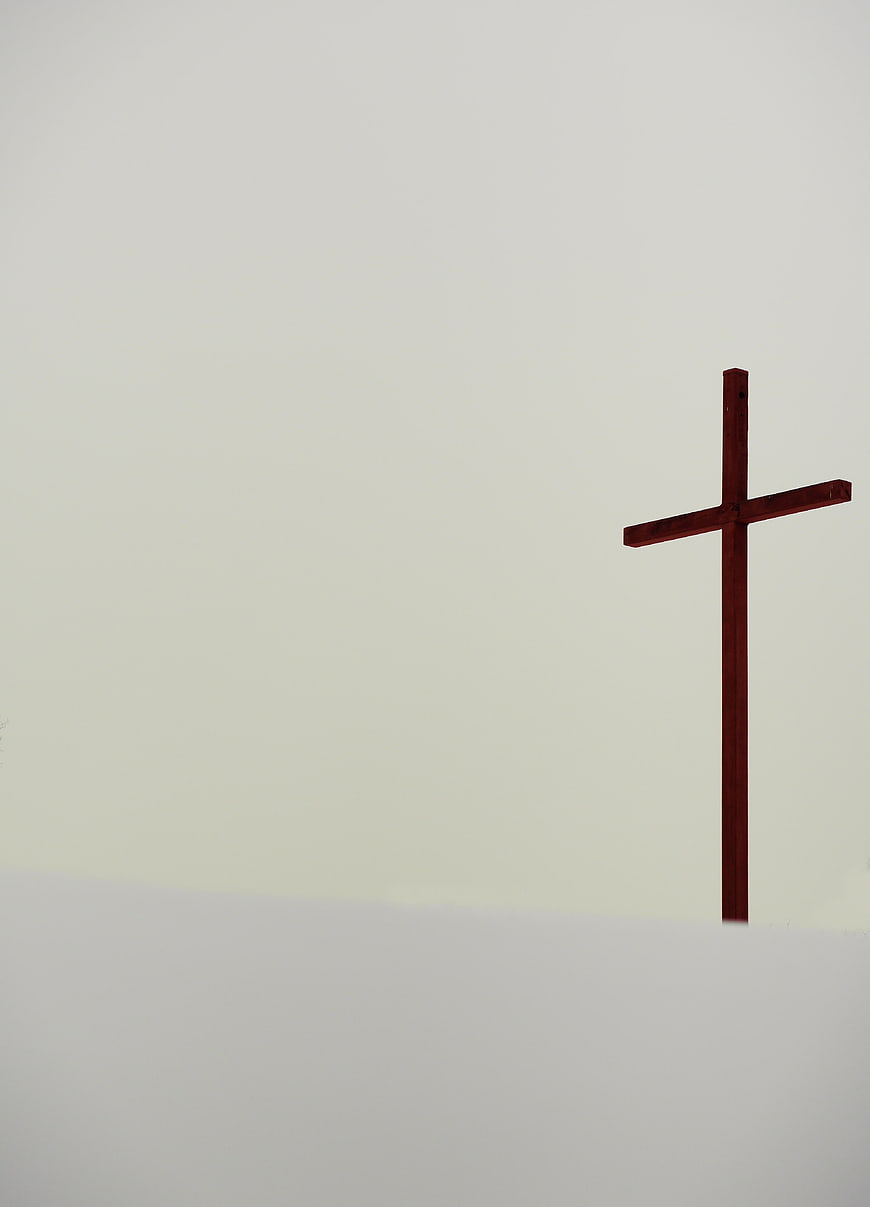 Minimalist Wooden Cross Against Foggy White Background