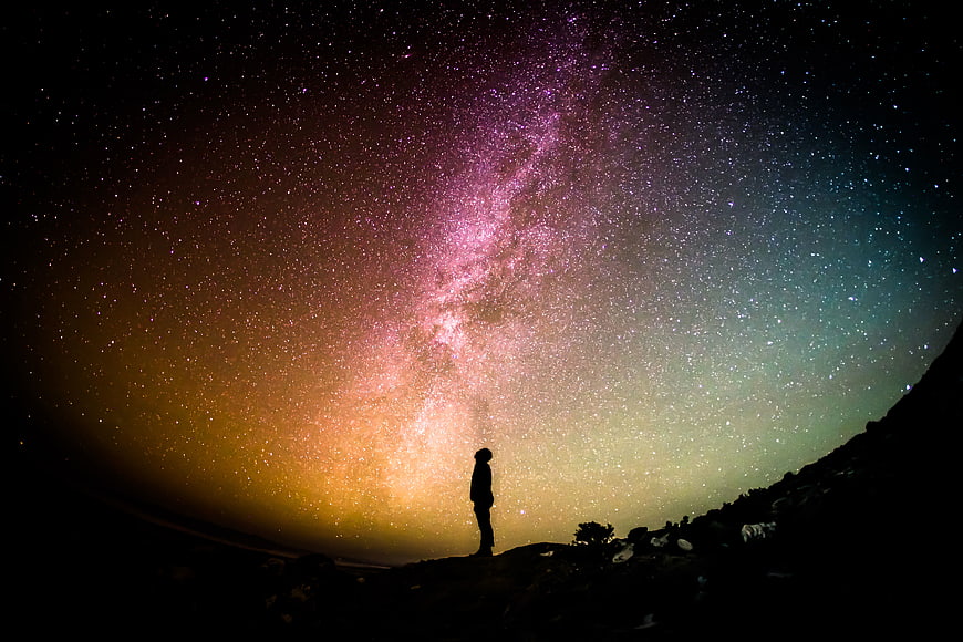 Silhouette of Person Under Milky Way Galaxy Night Sky