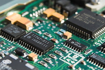 Close-up of green circuit board with electronic chips