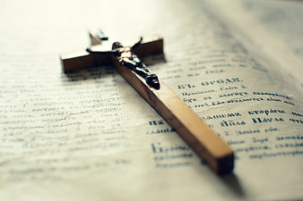 Wooden Cross Resting on Open Orthodox Bible Page